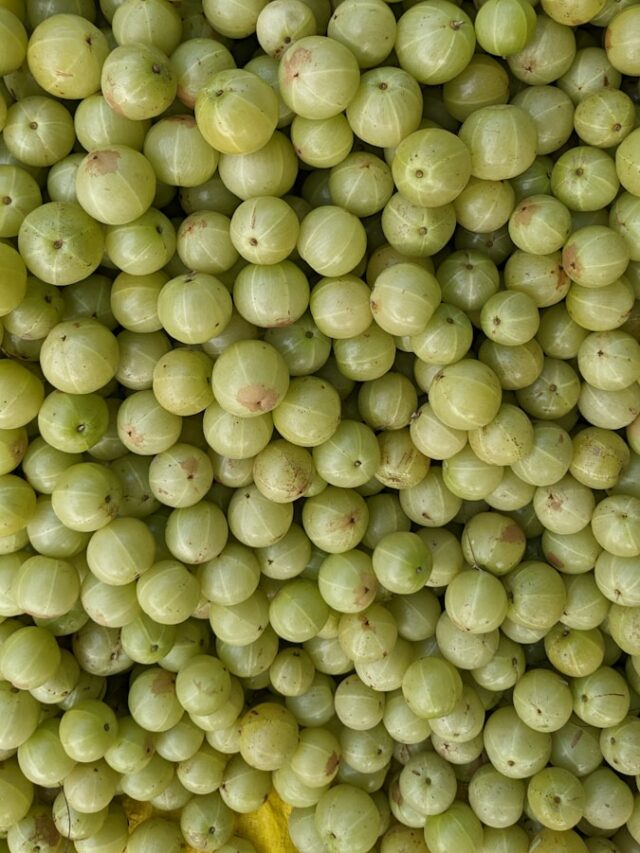 a bunch of grapes are stacked on top of each other