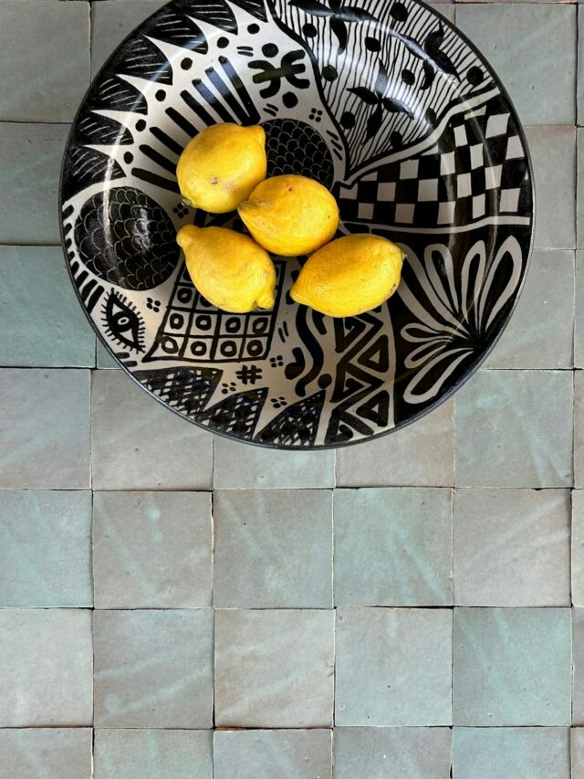 a black and white plate with lemons on it