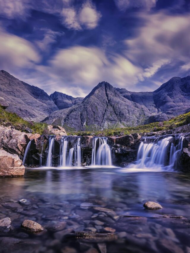 waterfalls under cloudy sky