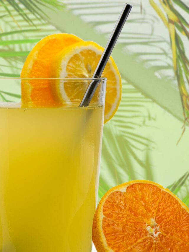 orange juice in clear drinking glass